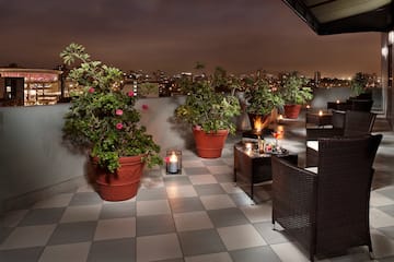 a patio with plants and candles on it