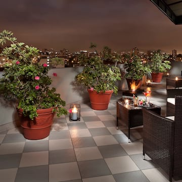 a patio with plants and candles on it