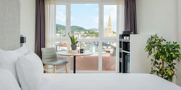 a room with a bed and a table and chairs