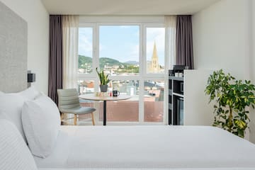 a room with a bed and a table and chairs