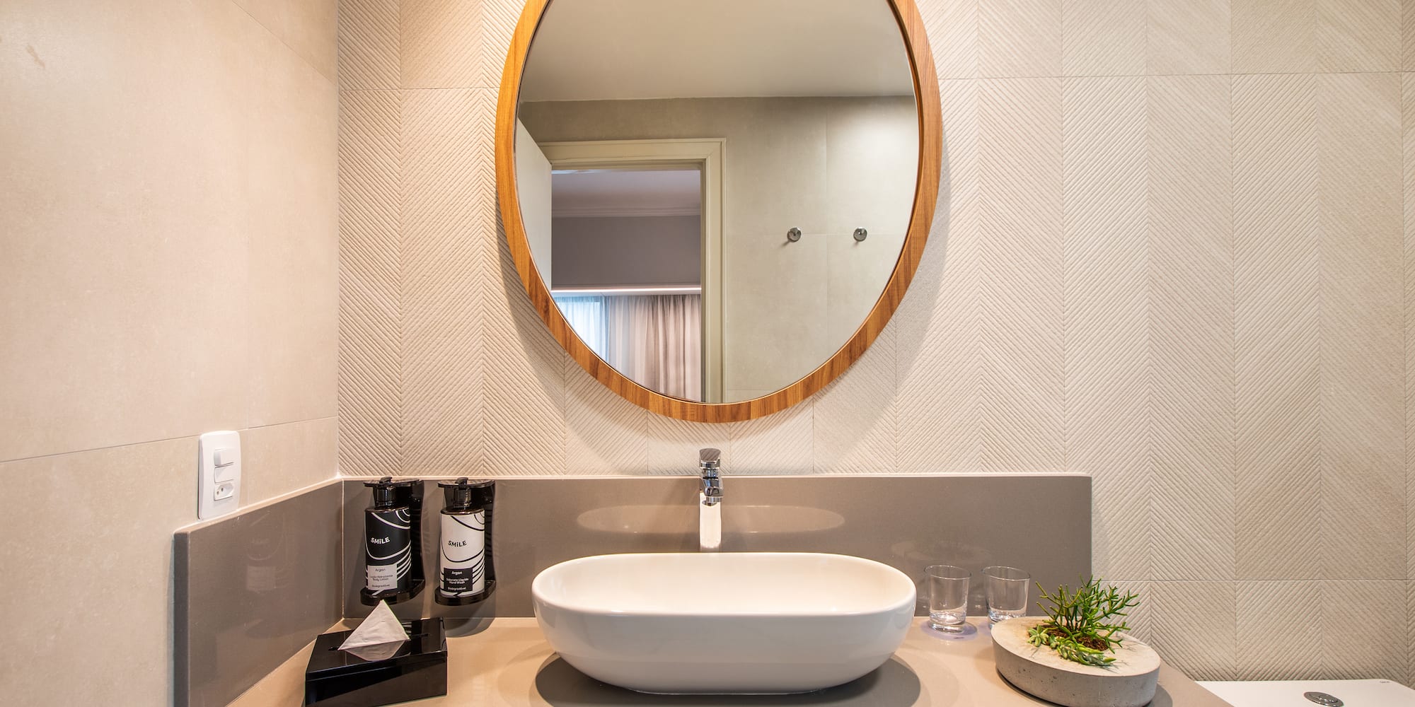 a bathroom with a round mirror