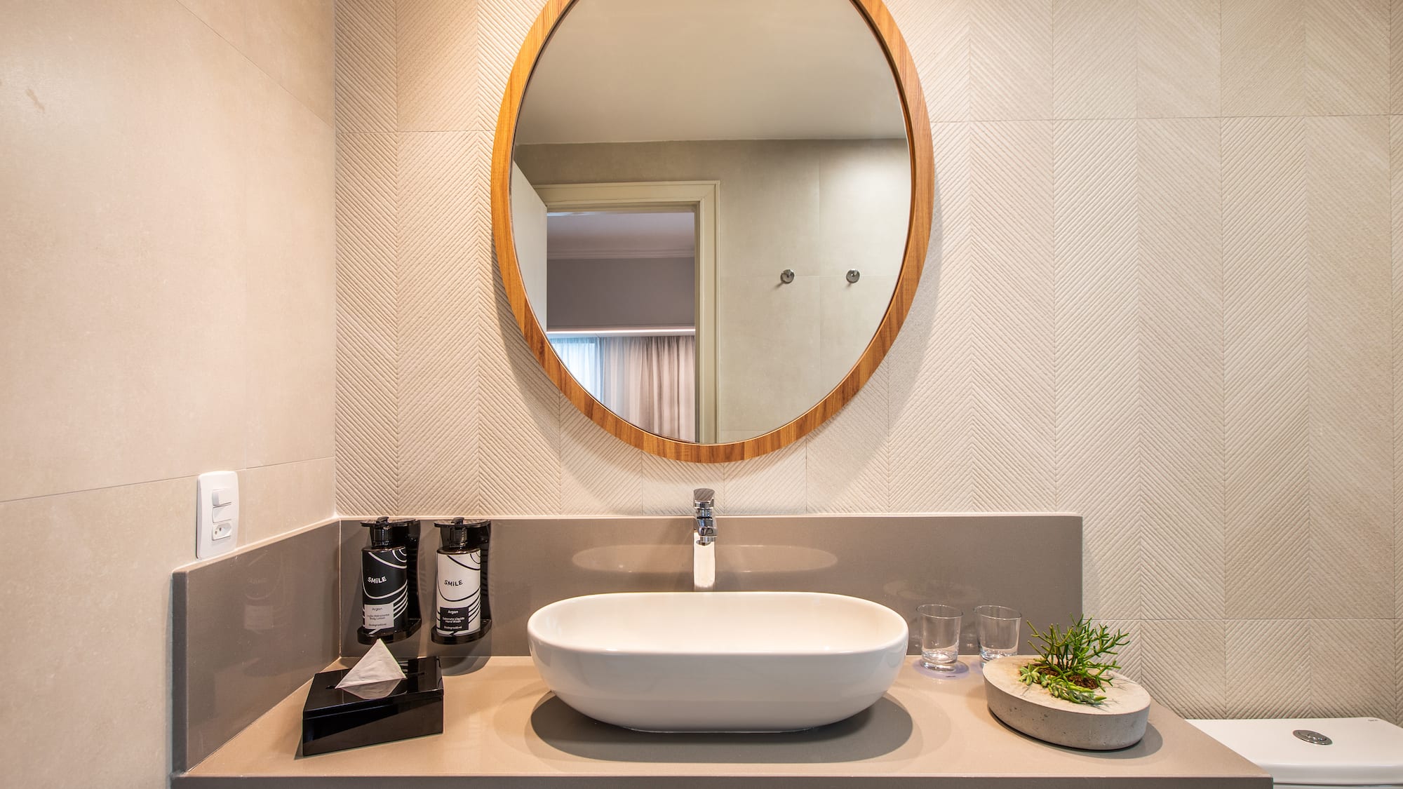 a bathroom with a round mirror