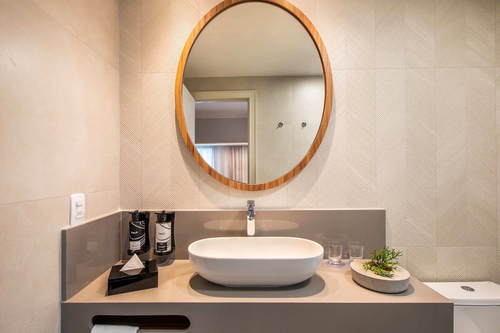a bathroom with a round mirror