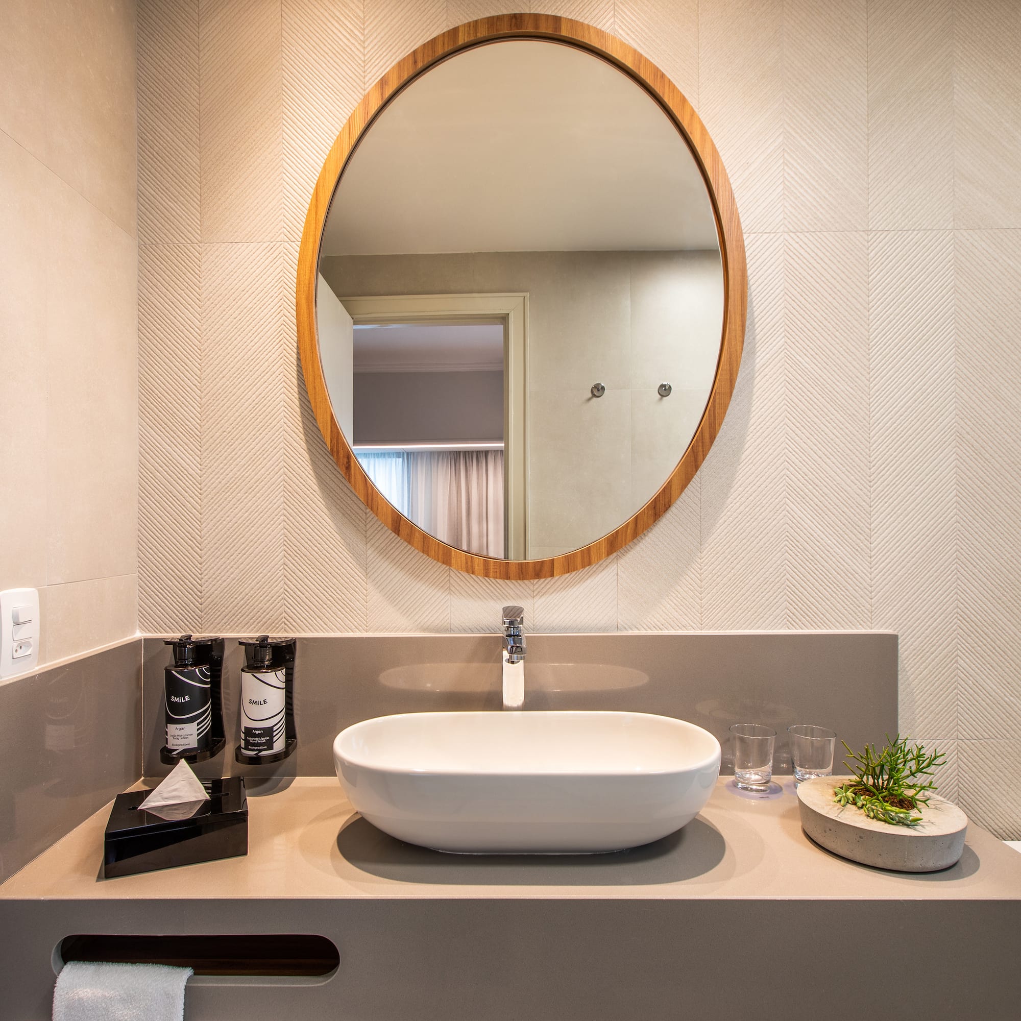 a bathroom with a round mirror