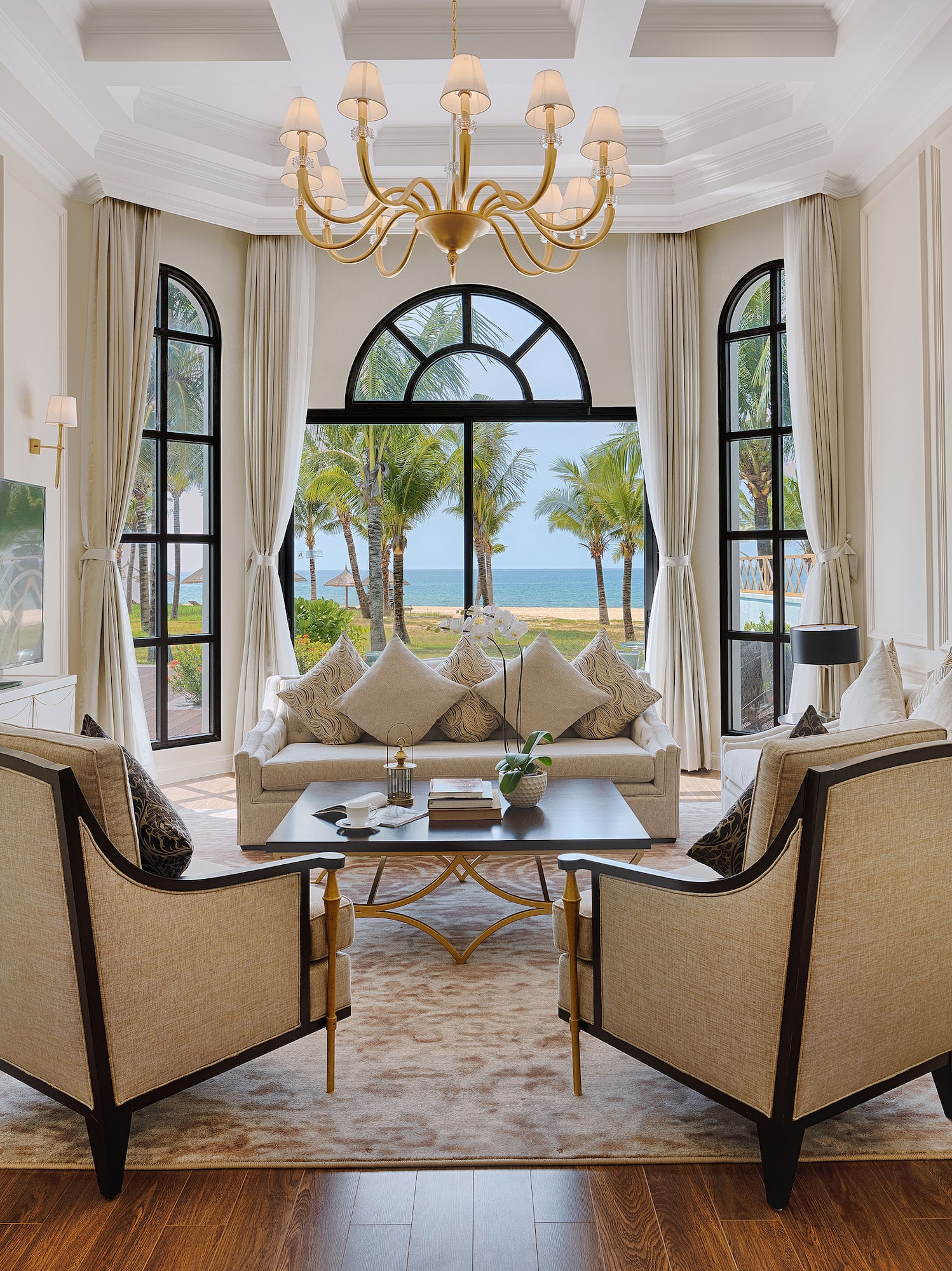 a living room with a large window and a couch and a table