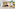 Hotel lobby with modern reception desk, retail display, plants, and directory.