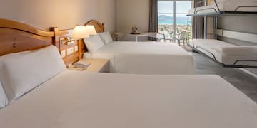 a room with two beds and a balcony