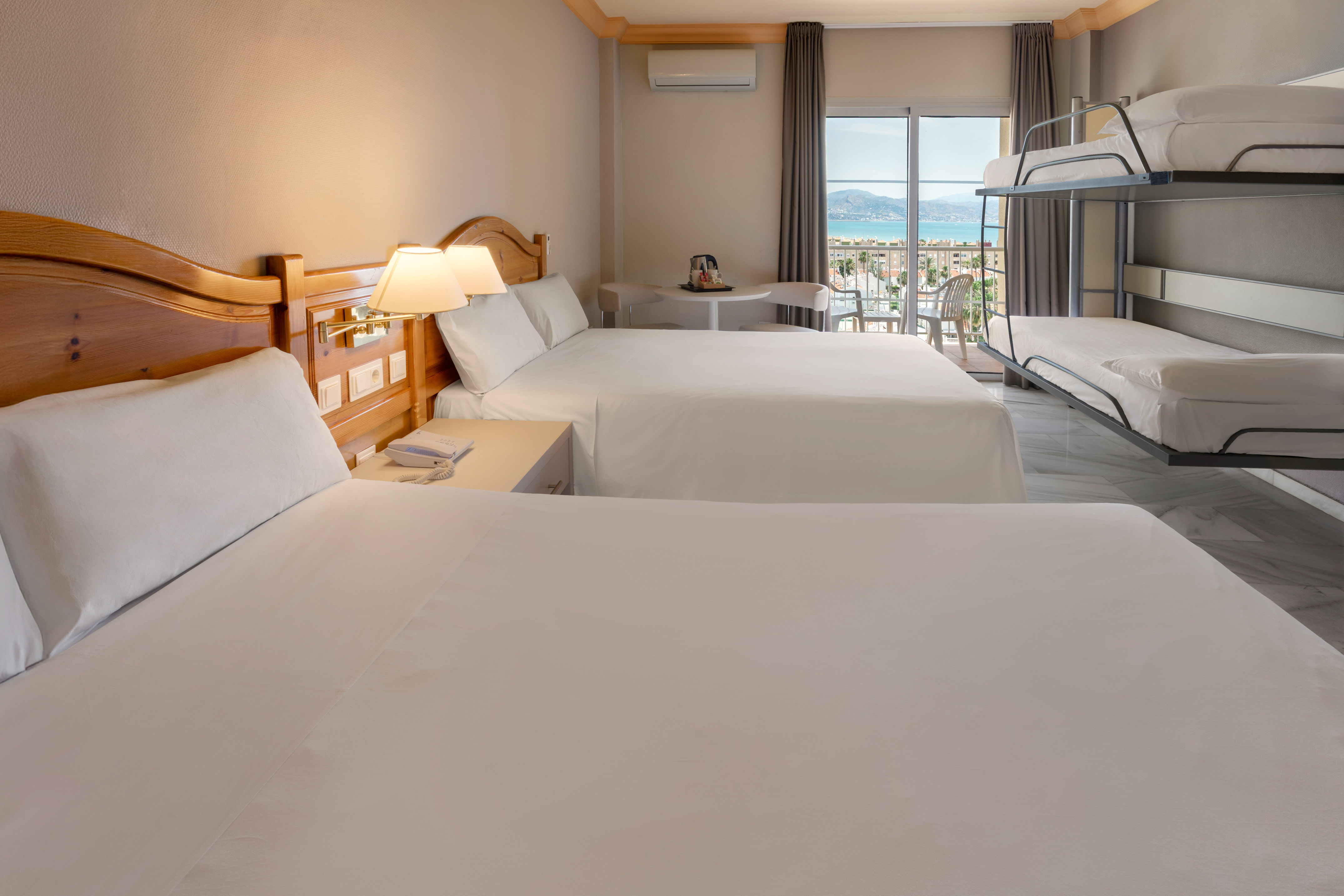 a room with two beds and a balcony