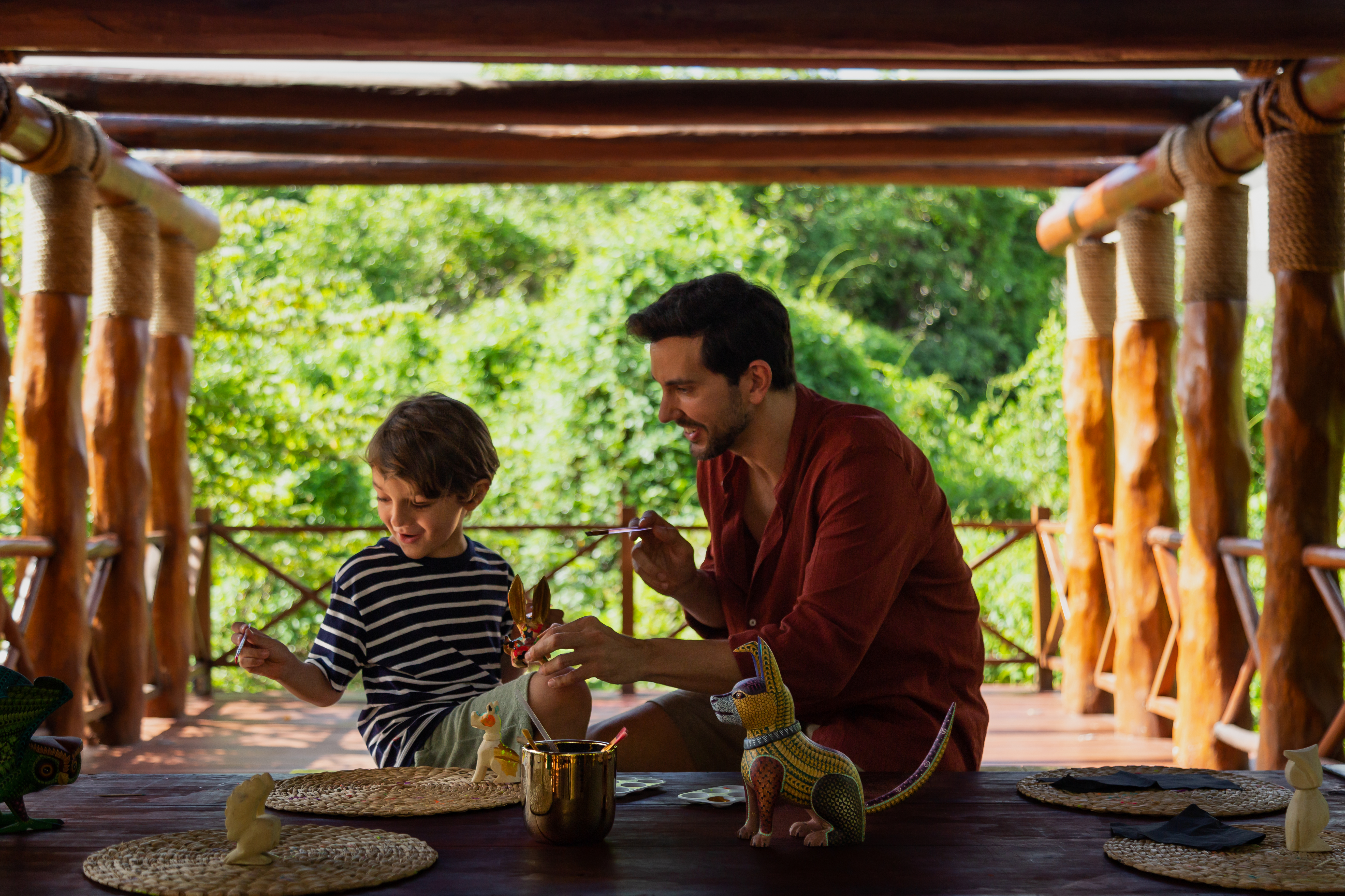 a man and child sitting at a table with toys