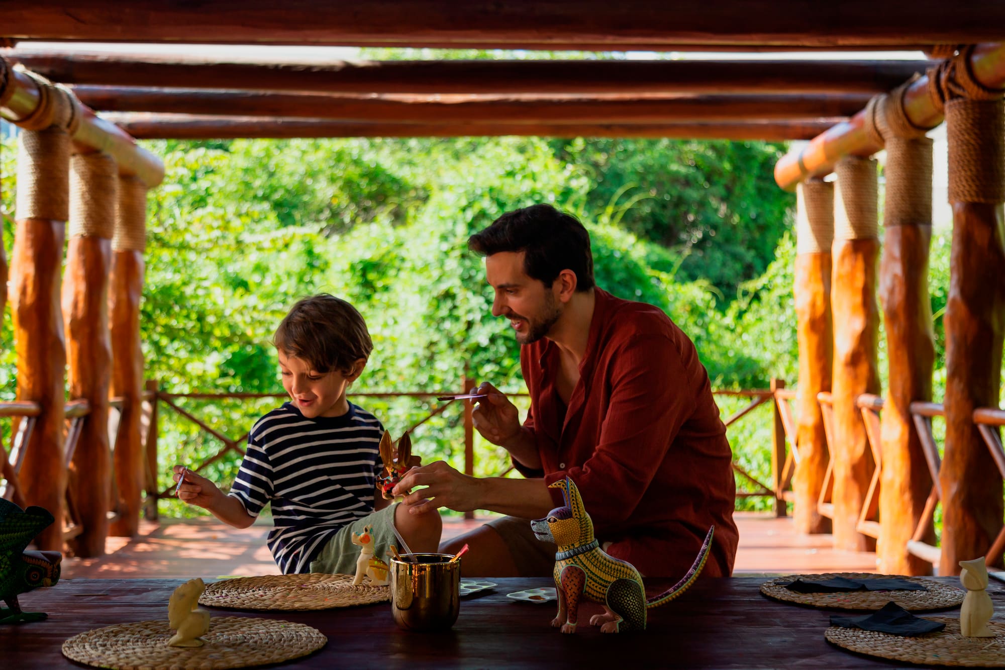 a man and child sitting at a table with toys
