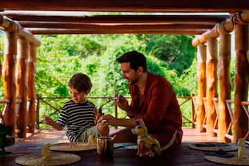 a man and child sitting at a table with toys