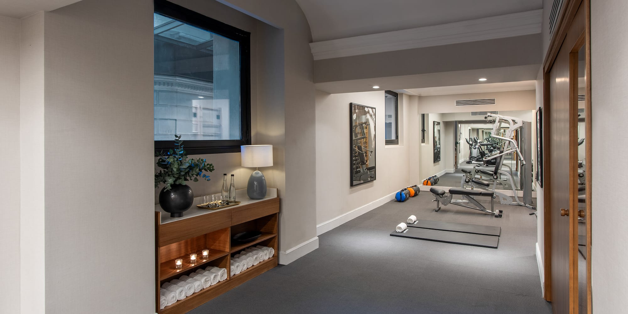 a room with exercise equipment and a mirror