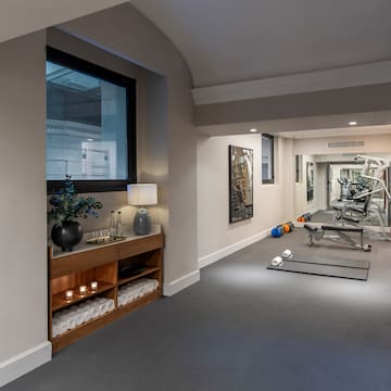 a room with exercise equipment and a mirror