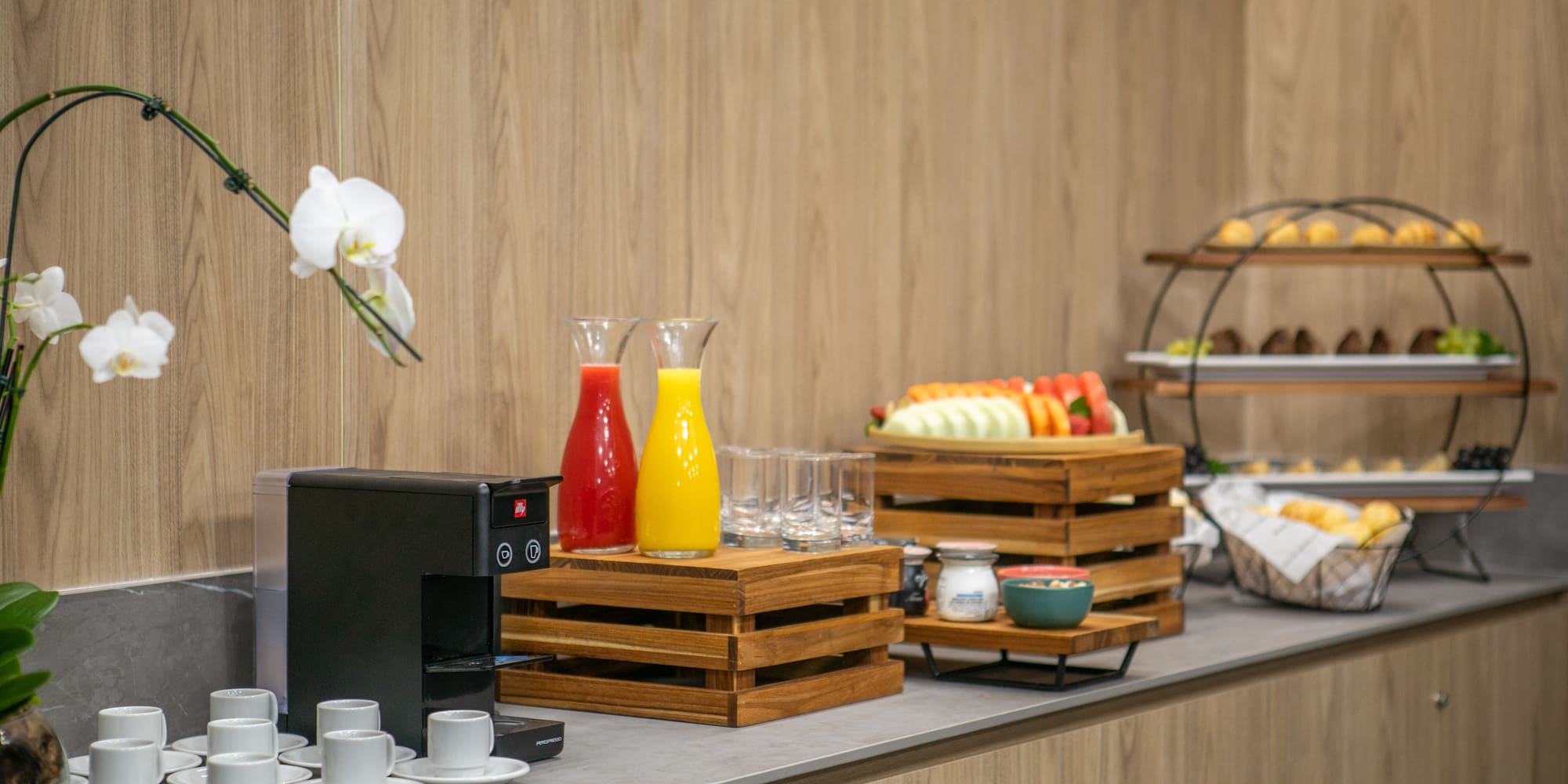 a coffee machine and fruit on a counter