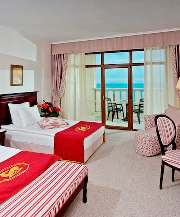 a room with two beds and a window
