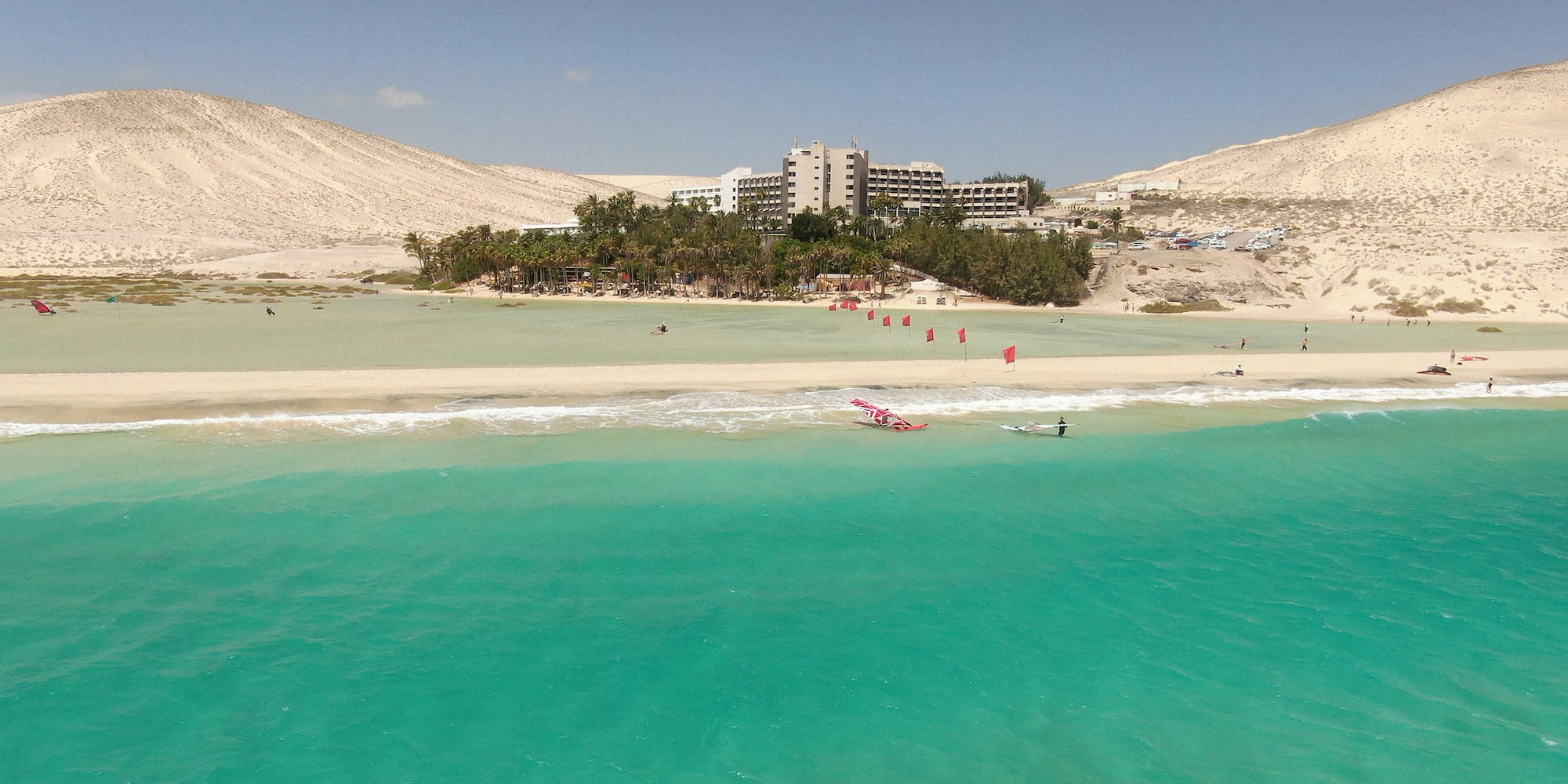 a beach with a building and trees