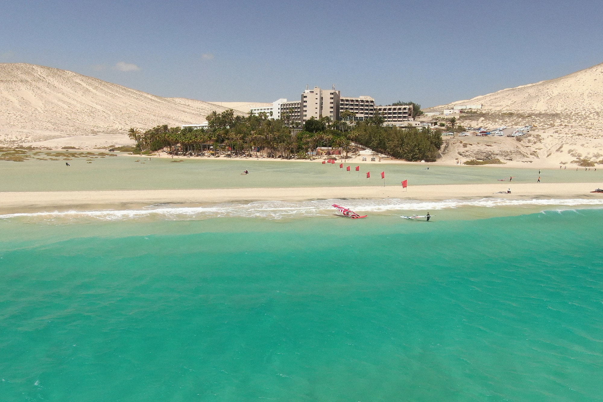a beach with a building and trees