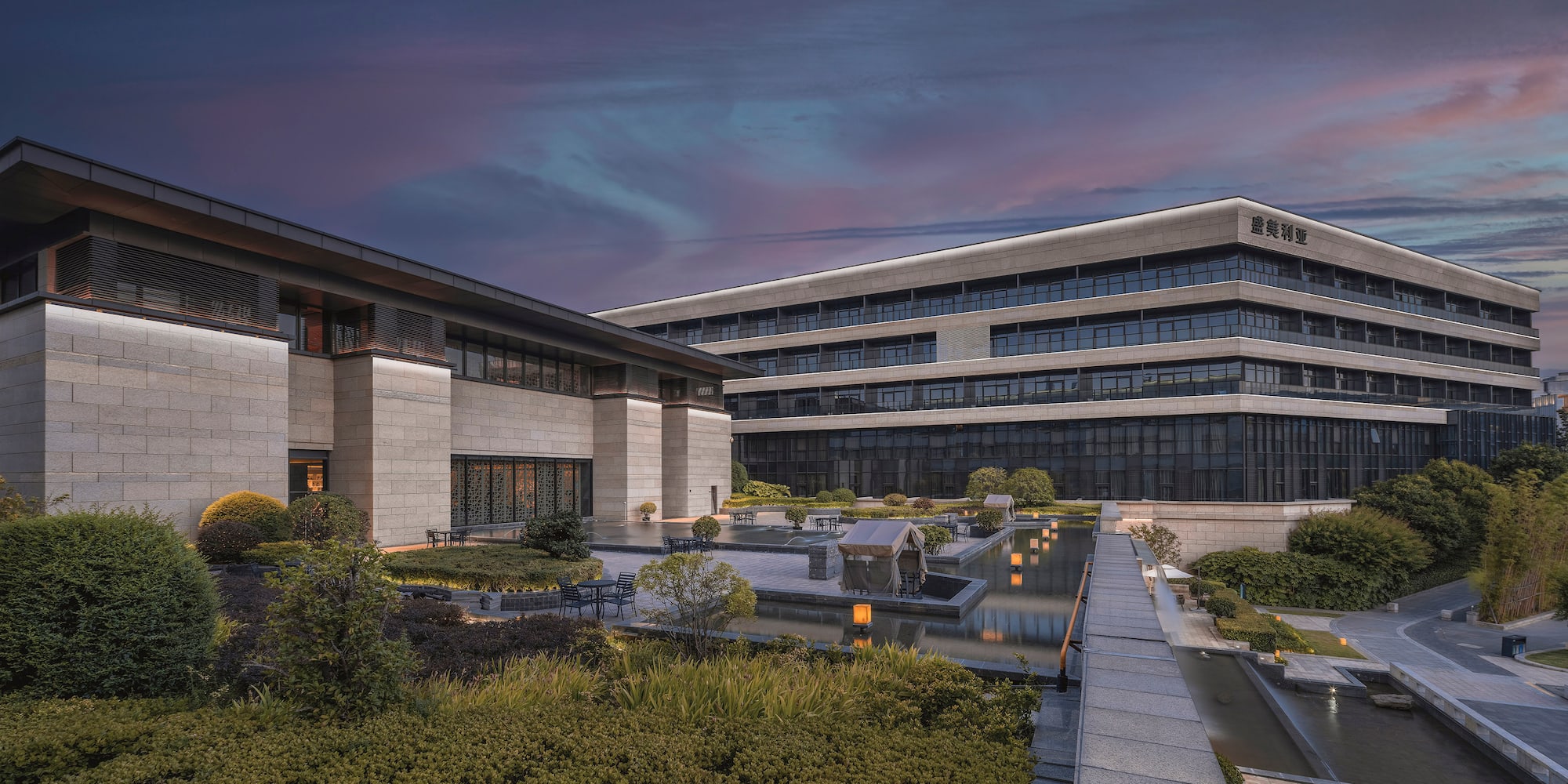 a building with a fountain and a walkway