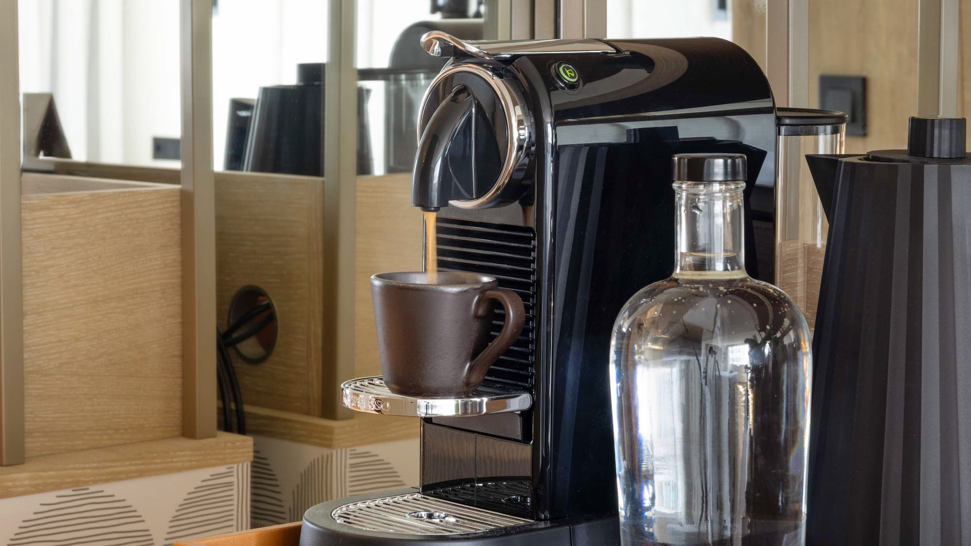 a coffee machine and a bottle on a shelf