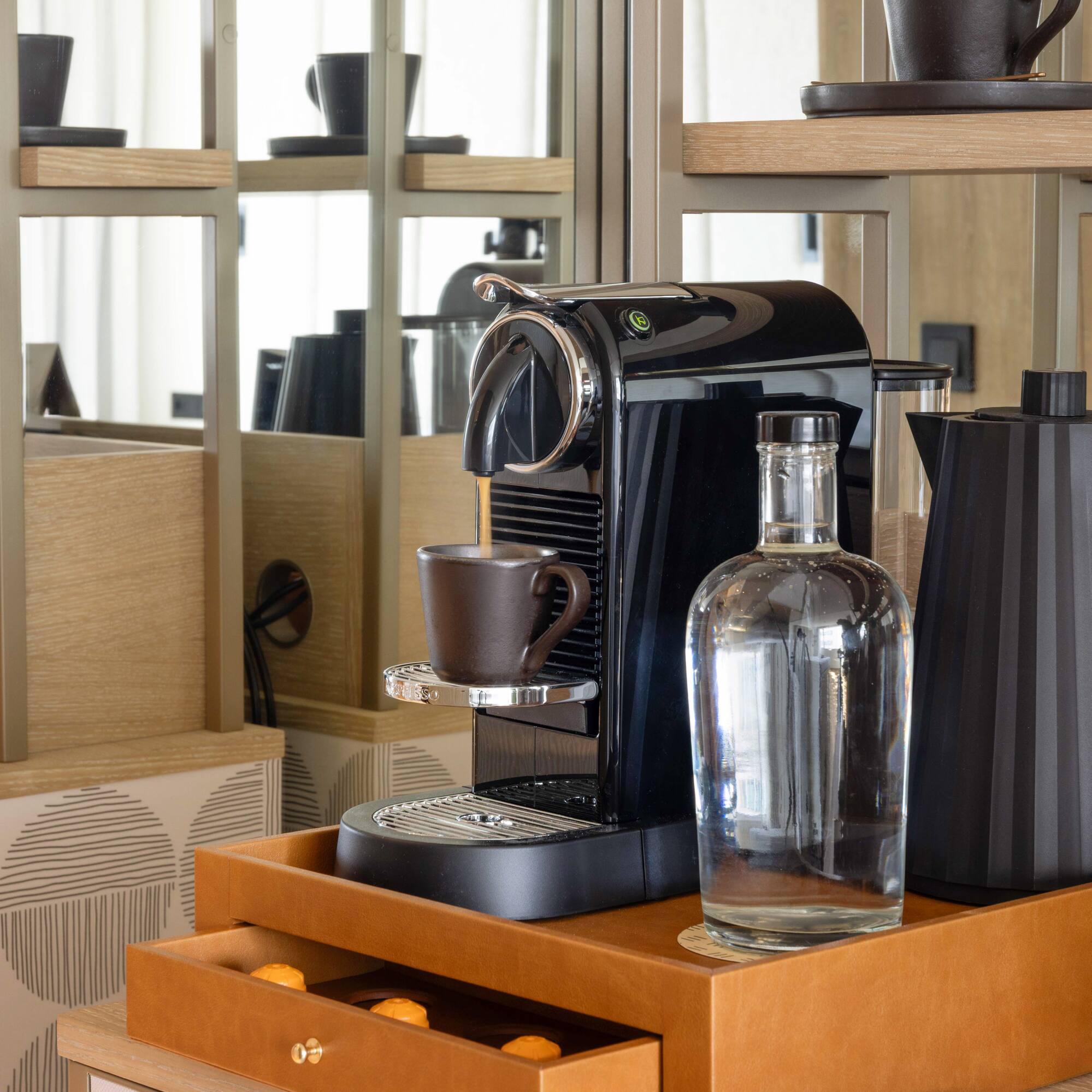 a coffee machine and a bottle on a shelf
