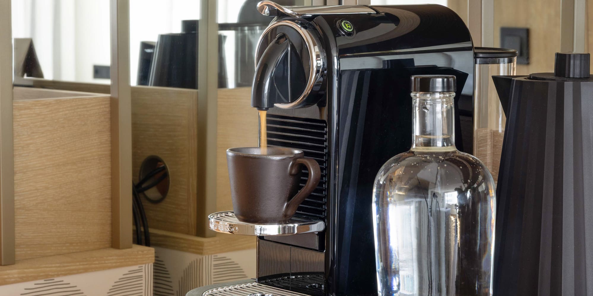 a coffee machine and a bottle on a shelf