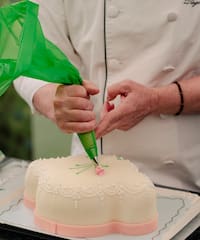 a person decorating a cake