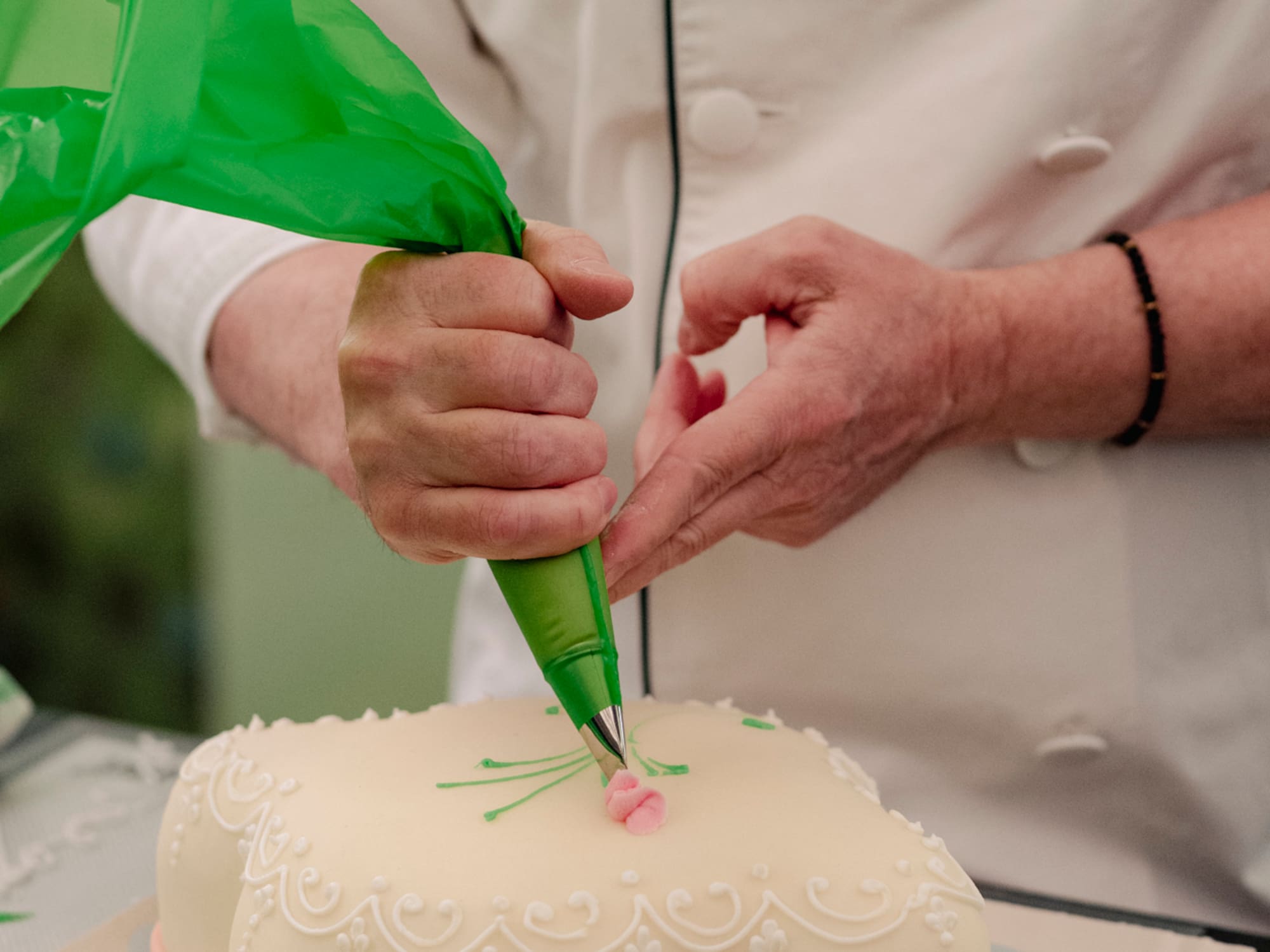 a person decorating a cake