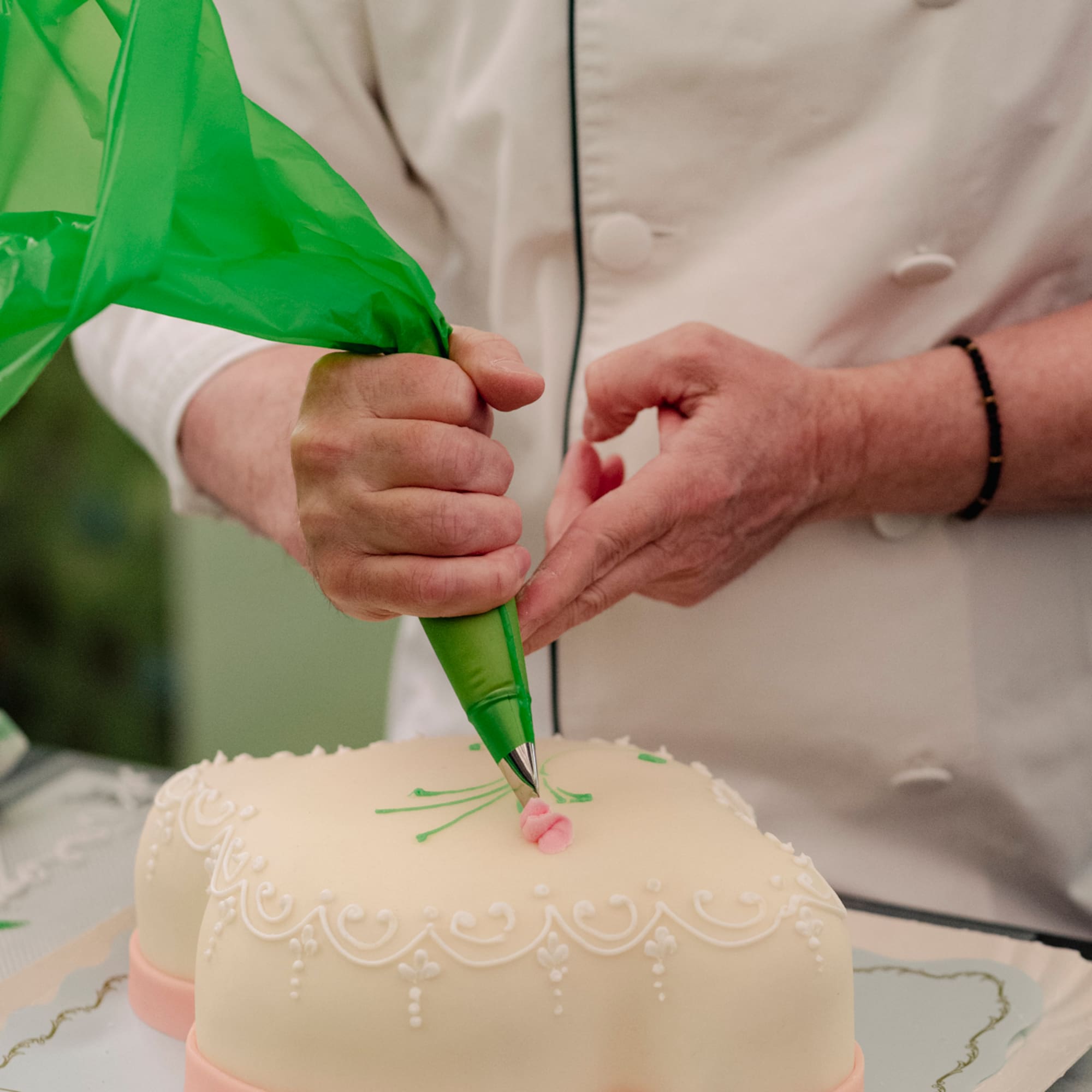 a person decorating a cake