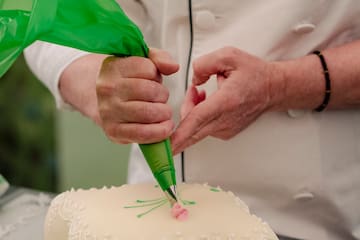 a person decorating a cake