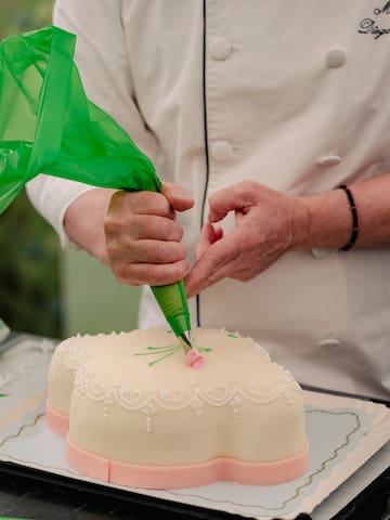 a person decorating a cake