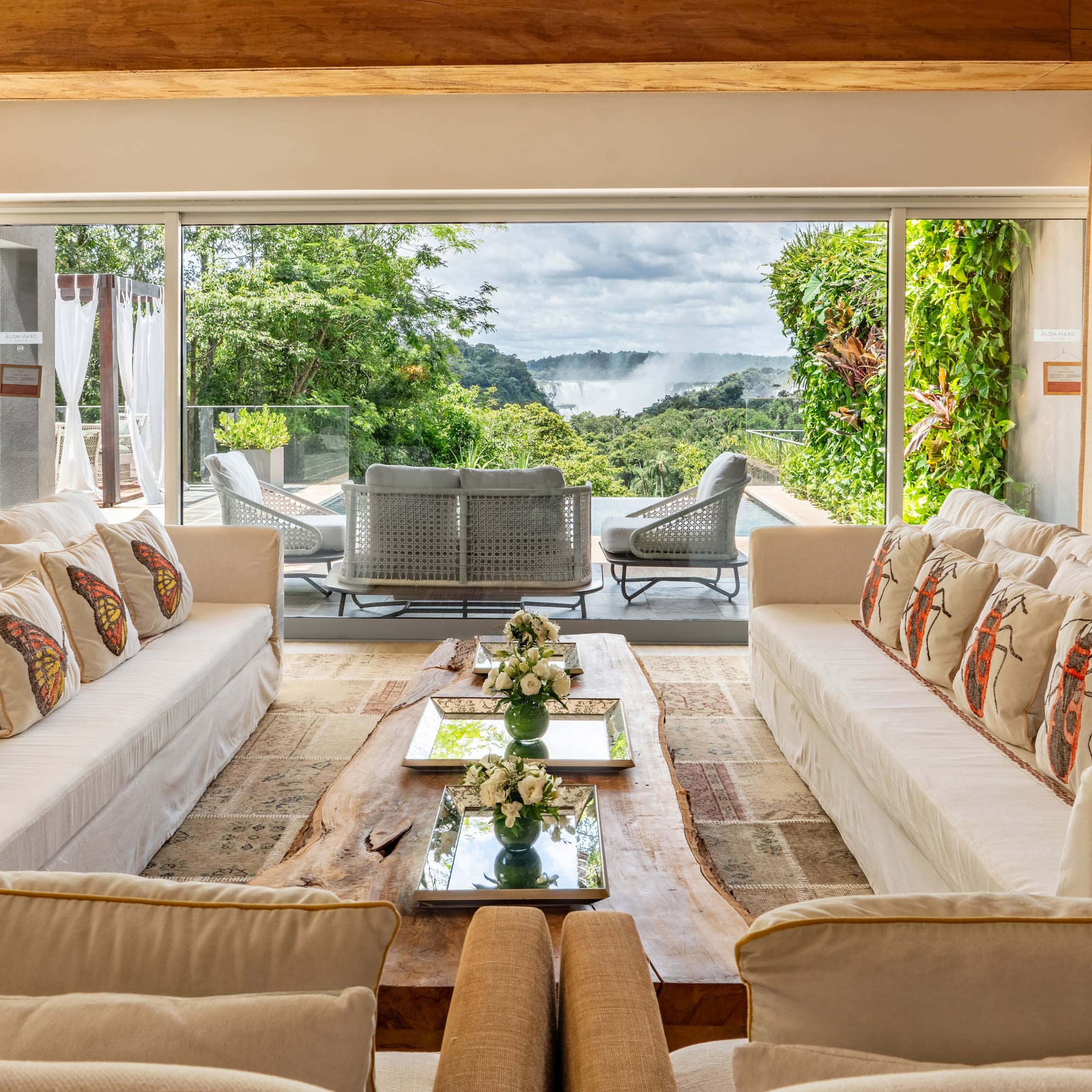 a living room with large windows and couches