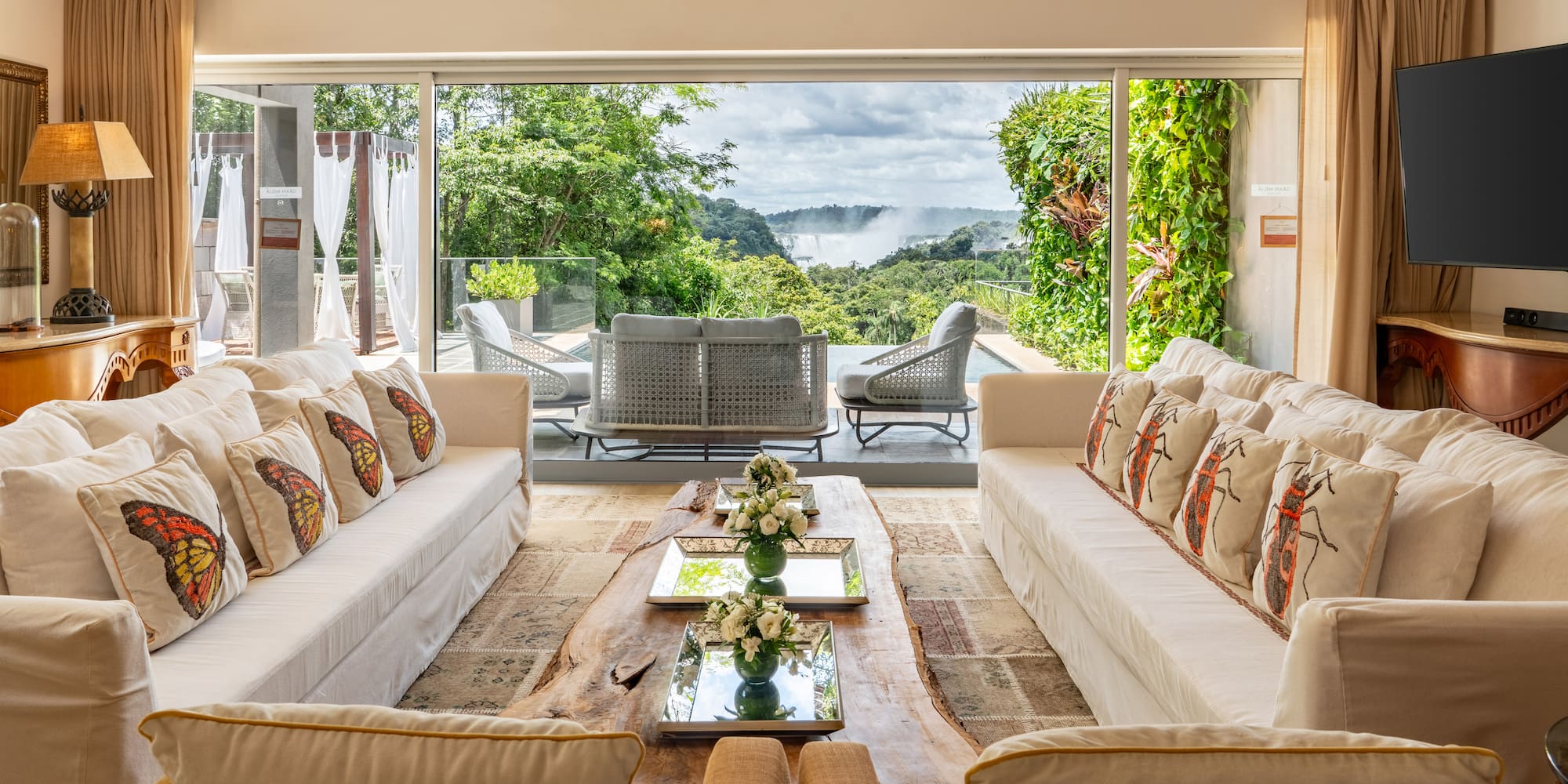 a living room with large windows and couches