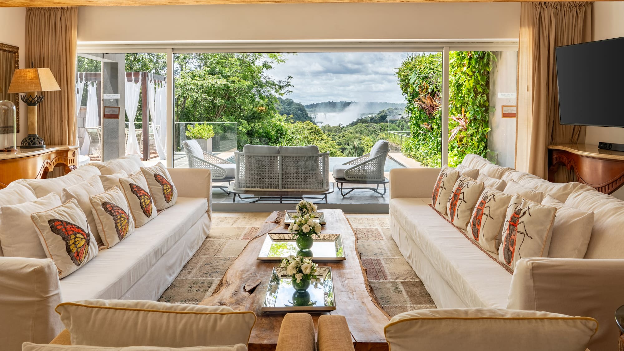 a living room with large windows and couches