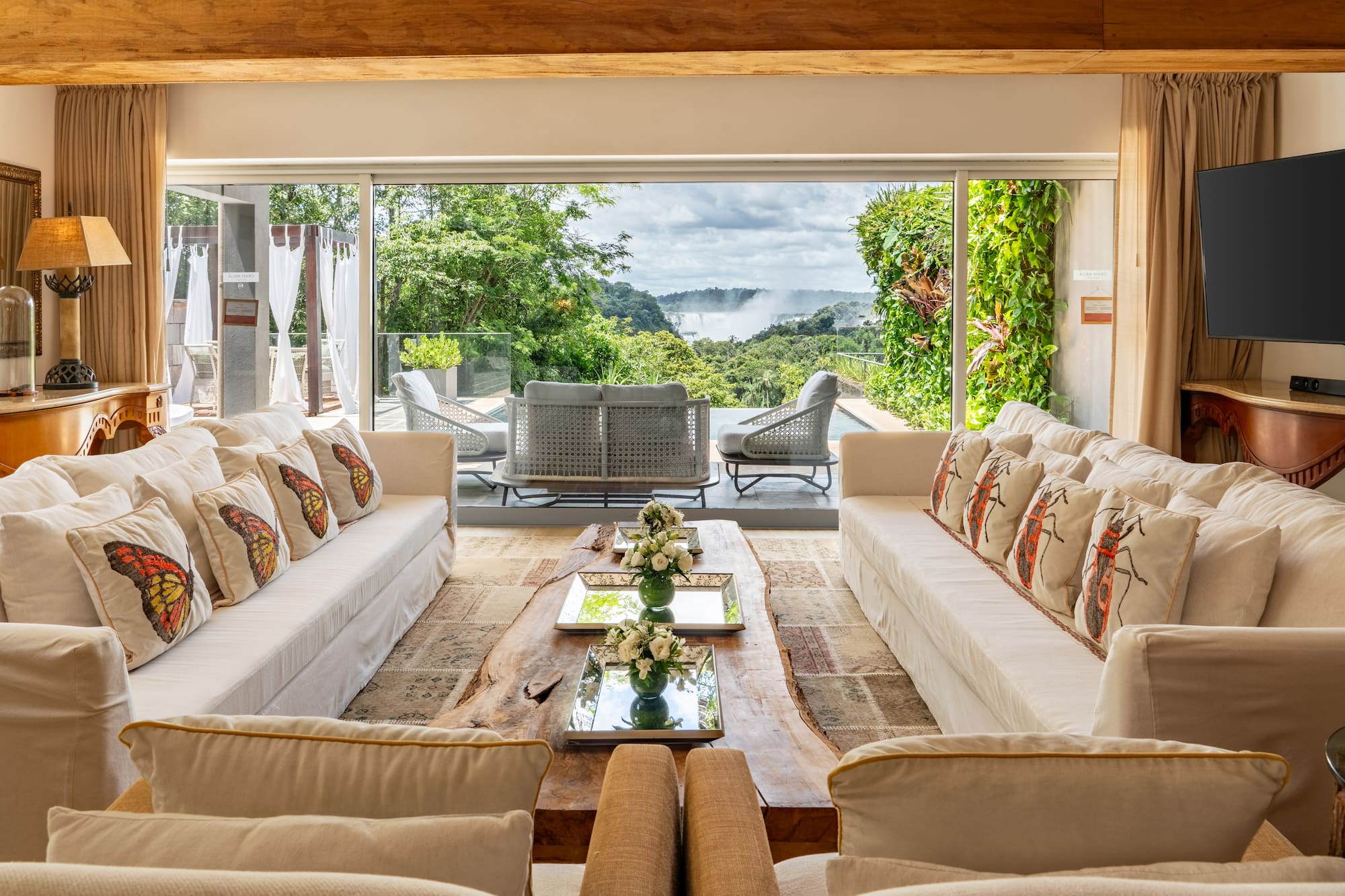 a living room with large windows and couches