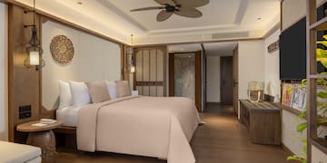 a bedroom with a television and a bed