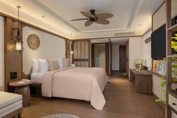 a bedroom with a television and a bed