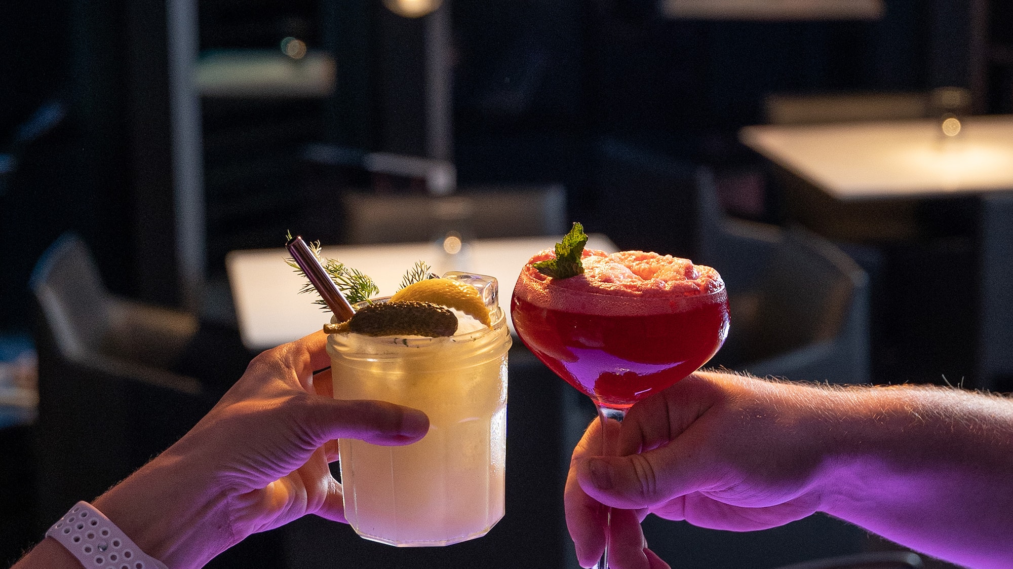 a pair of hands holding drinks