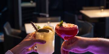 a pair of hands holding drinks