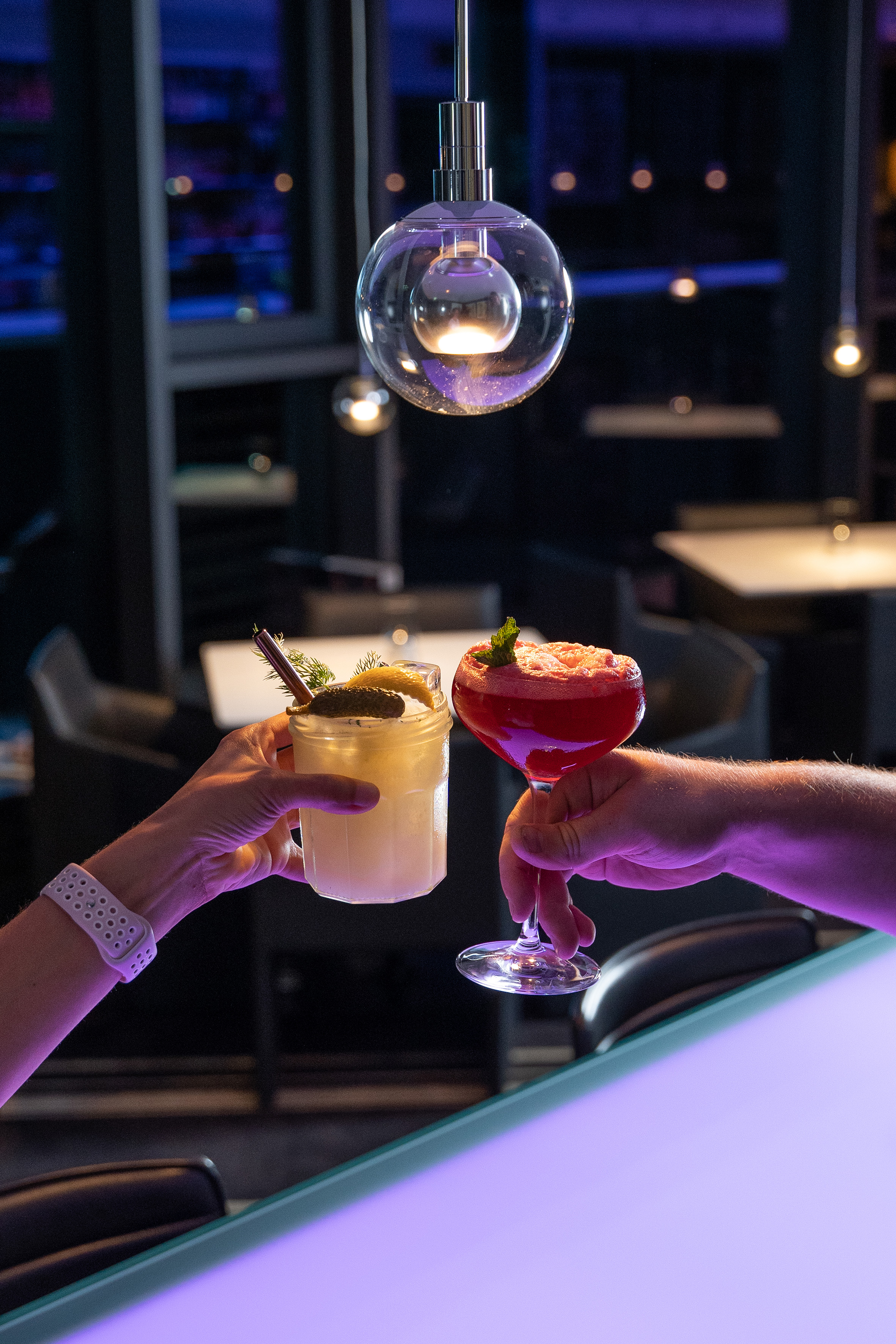 a pair of hands holding drinks