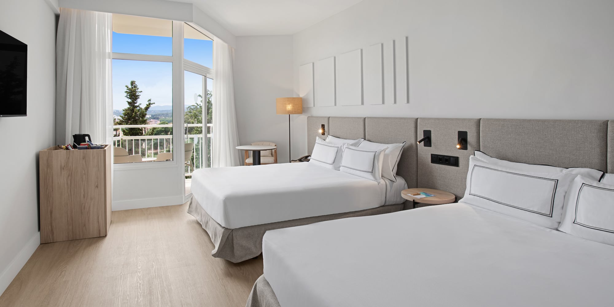 a room with two beds and a balcony