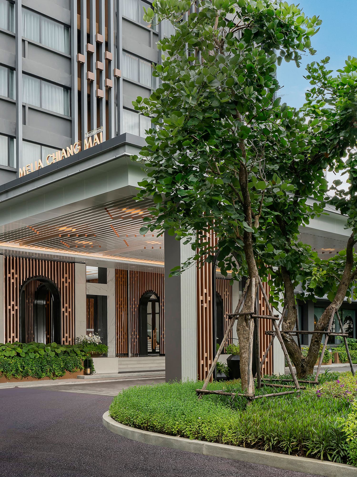a building with trees and a walkway