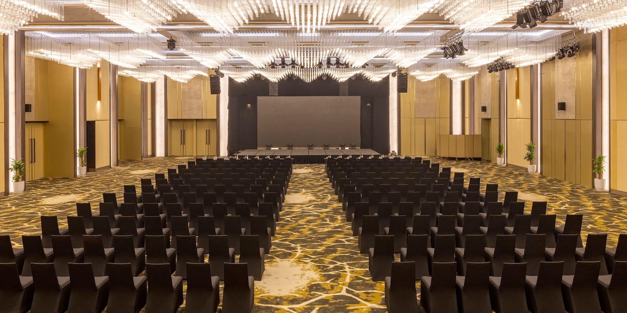 a room with black chairs and a stage