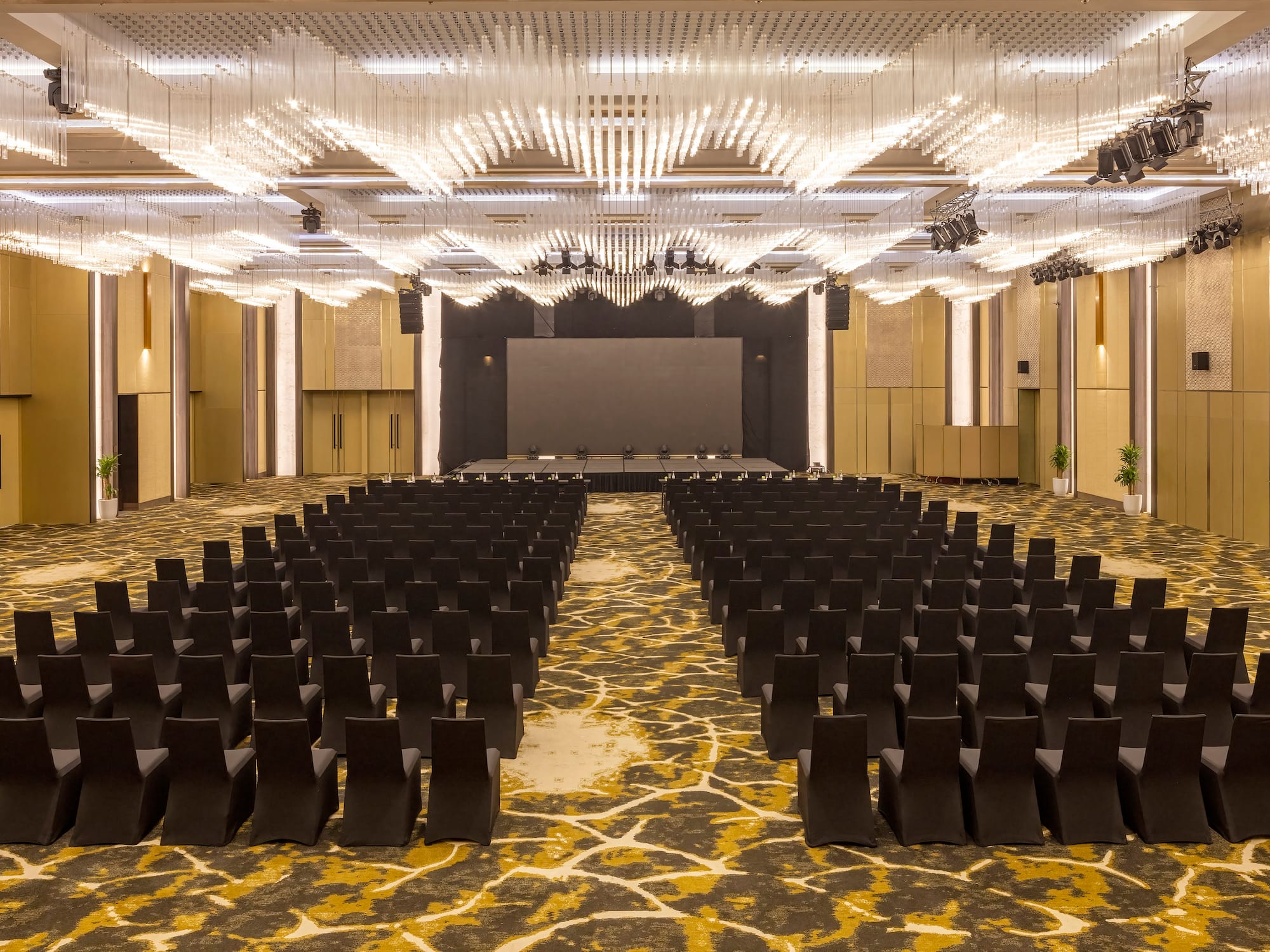 a room with black chairs and a stage