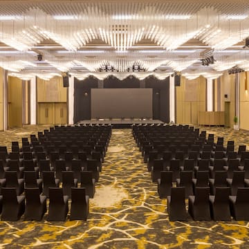 a room with black chairs and a stage