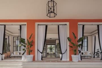 a building with white curtains and plants