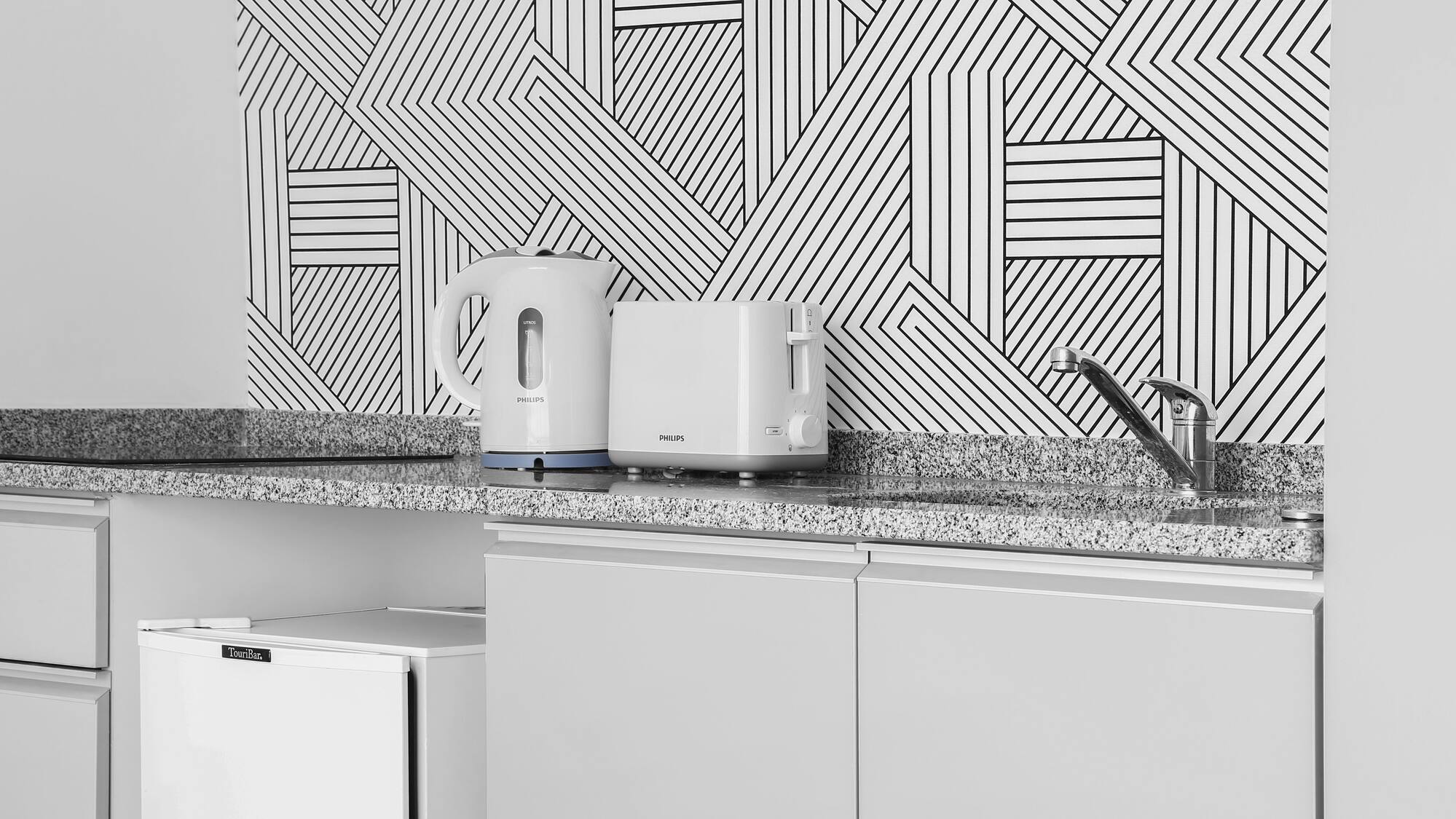 a white toaster and a toaster on a counter