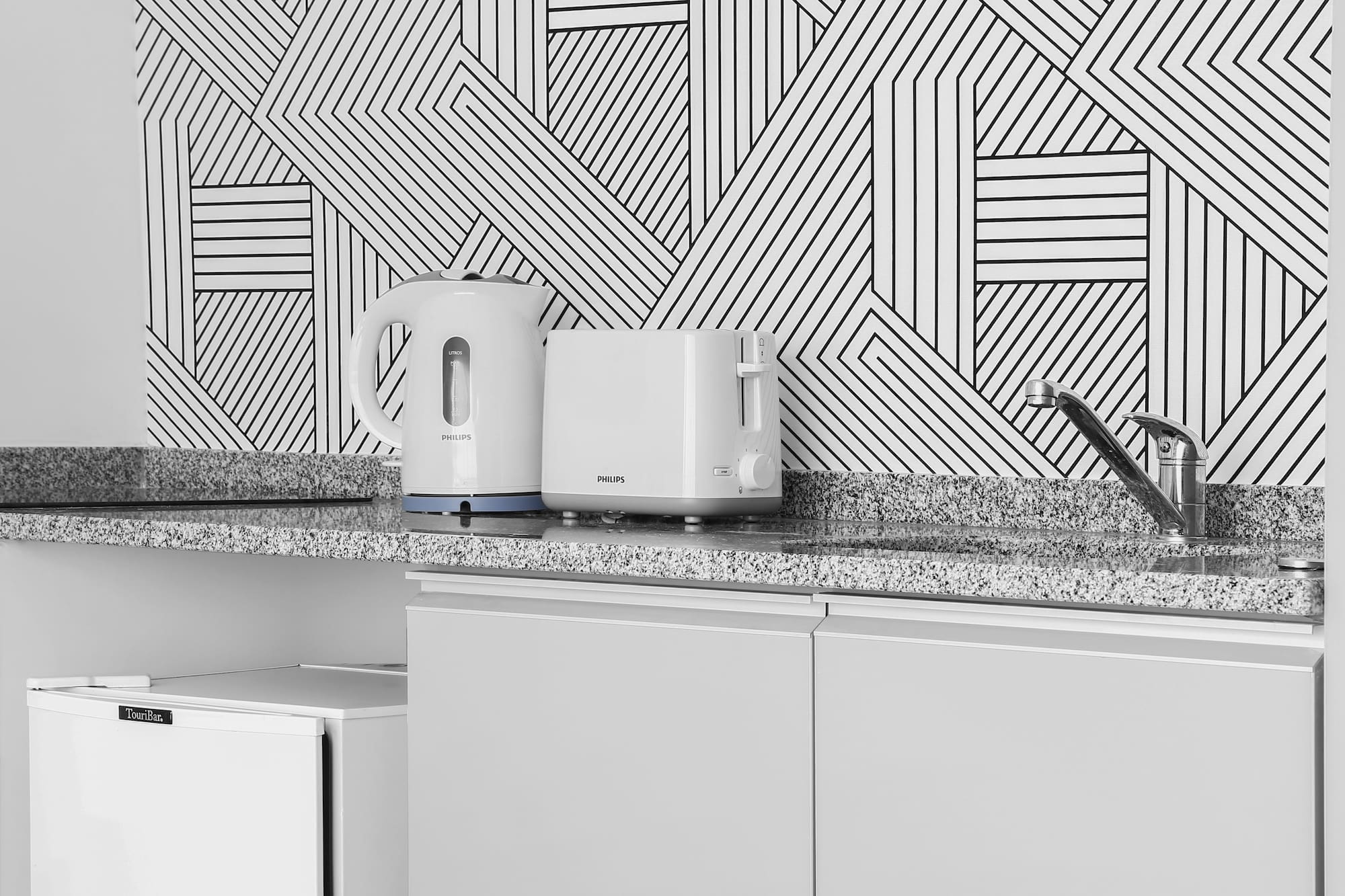 a white toaster and a toaster on a counter