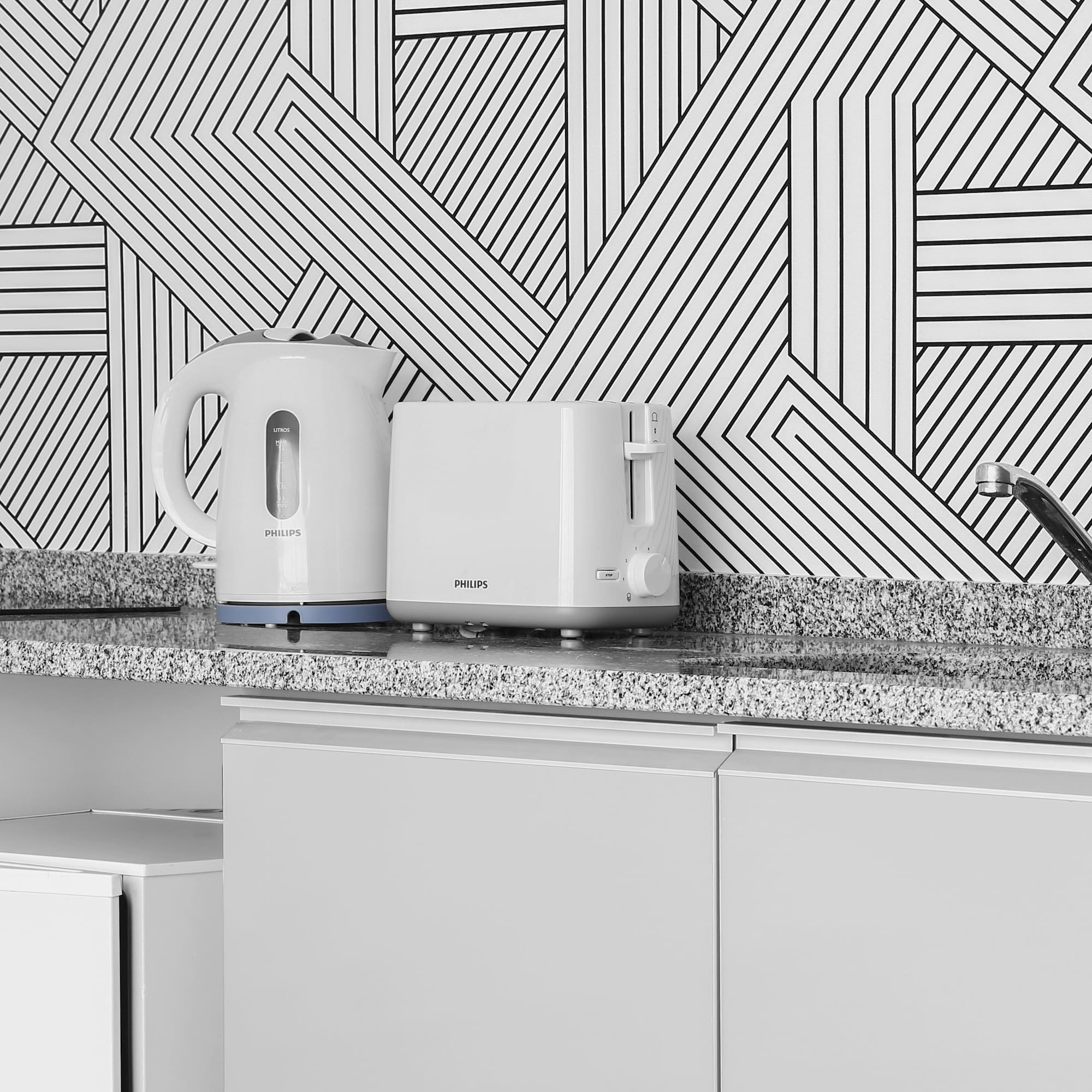 a white toaster and a toaster on a counter