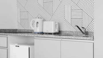 a white toaster and a toaster on a counter