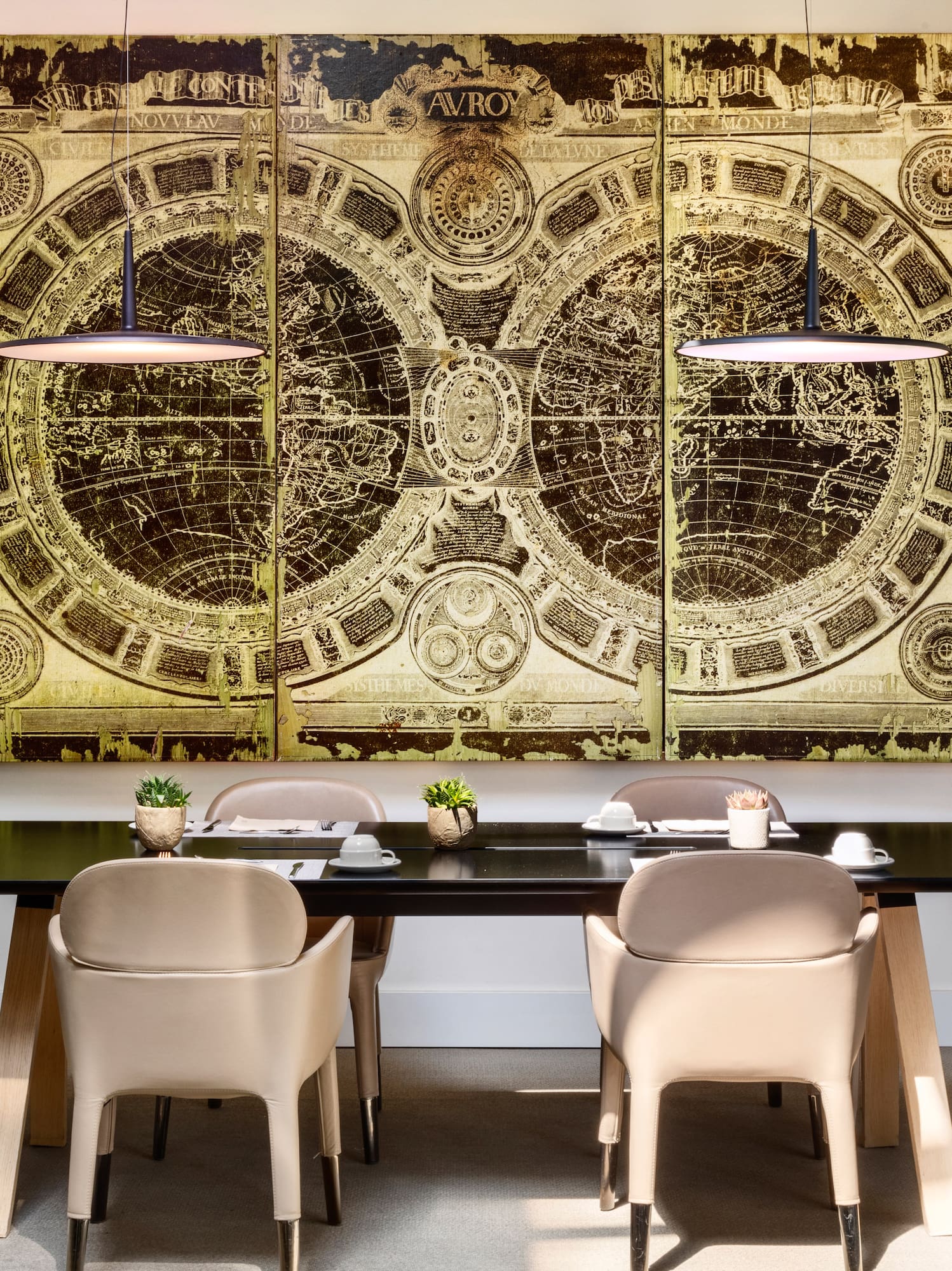 a table with chairs and a large painting on the wall